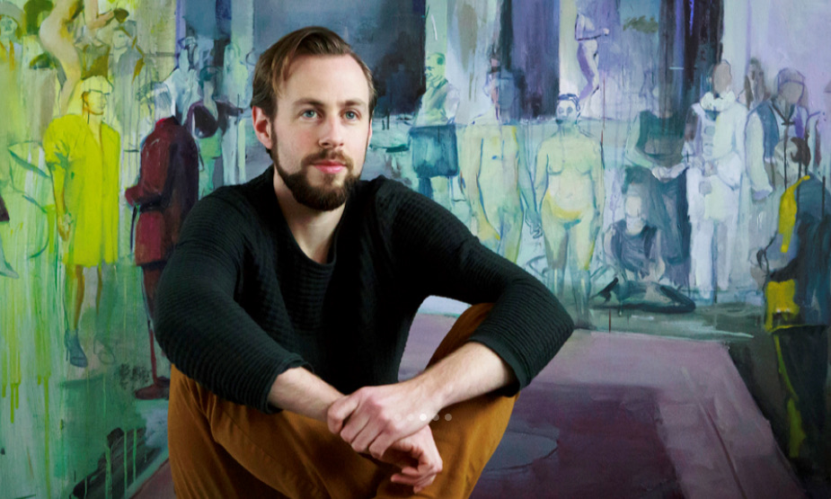 Casper Verborg seated in his studio, in front of a large painting